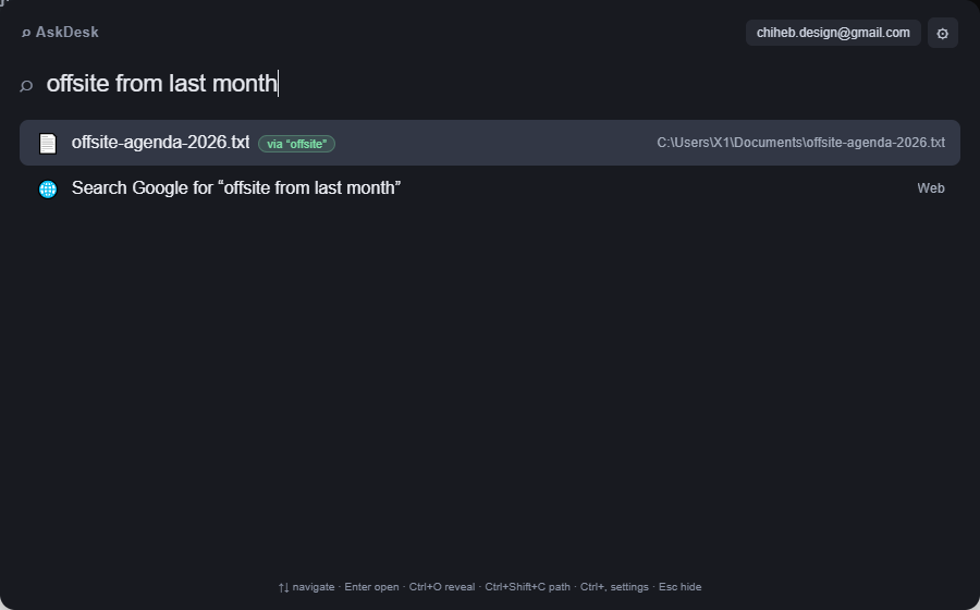 The AskDesk command bar. The query reads "offsite from last month" and returns offsite-agenda-2026.txt with a green "via offsite" badge, resolved on this PC without a model.